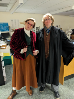 Two women in Halloween costumes pose majestically