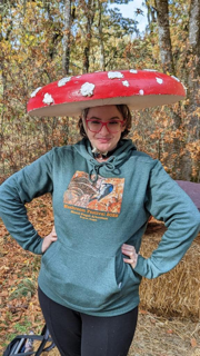 A woman wears a mushroom hat